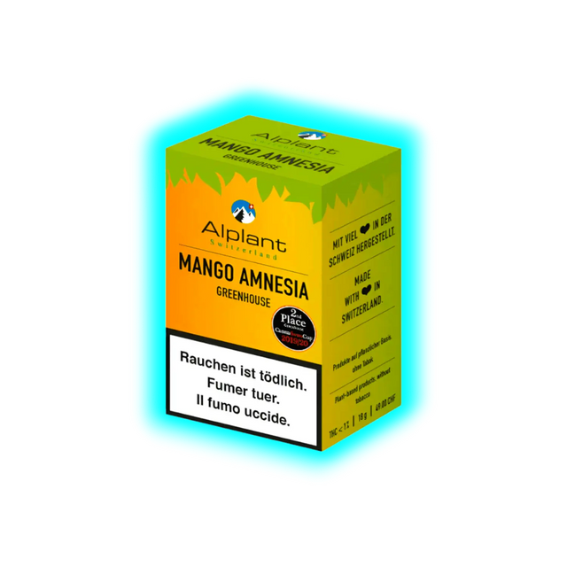 Gelbe Verpackung mit grünem Deckel der Marke Alplant mit der Aufschrift 'Mango Amnesia Greenhouse' und Warnhinweis in Deutsch, Französisch und Italienisch