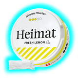 Runde Dose mit Schriftzug Heimat FRESH LEMON und gelb-weißen Designstreifen sowie danebenliegendem weißen Portionsbeutel