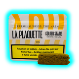 Design-Verpackung für „LA PLAQUETTE GOLDEN STATE“ mit beiliegendem braunem Hasch-Fragment.