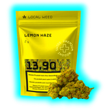 Gelbe Verpackung mit der Aufschrift 'LOCAL WEED LEMON HAZE 2g' und Preisangabe '13.90' neben zwei Cannabisblüten